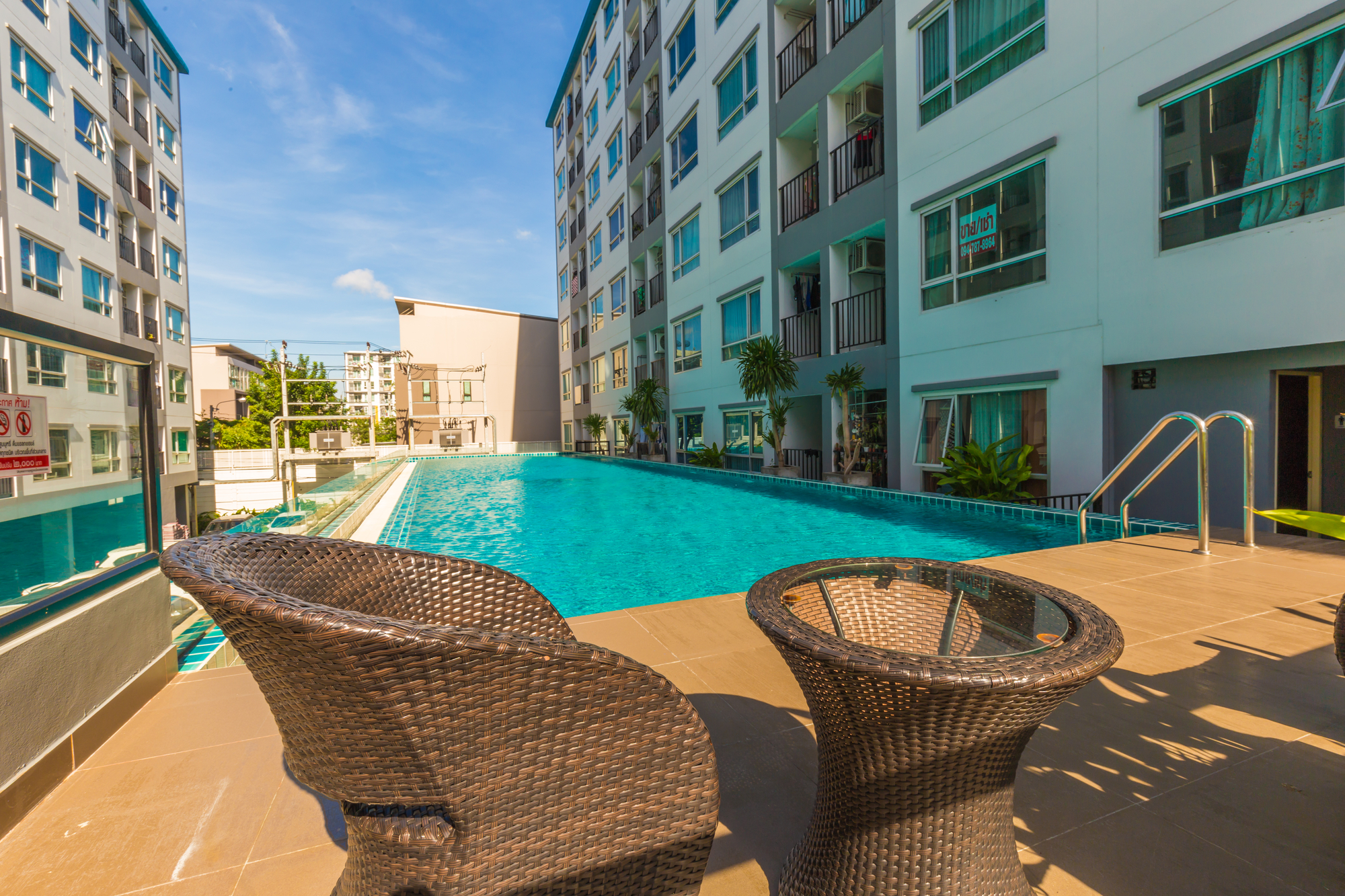 Condomunium building with swimming pool Condomunium building with swimming pool sun shine and blue sky day