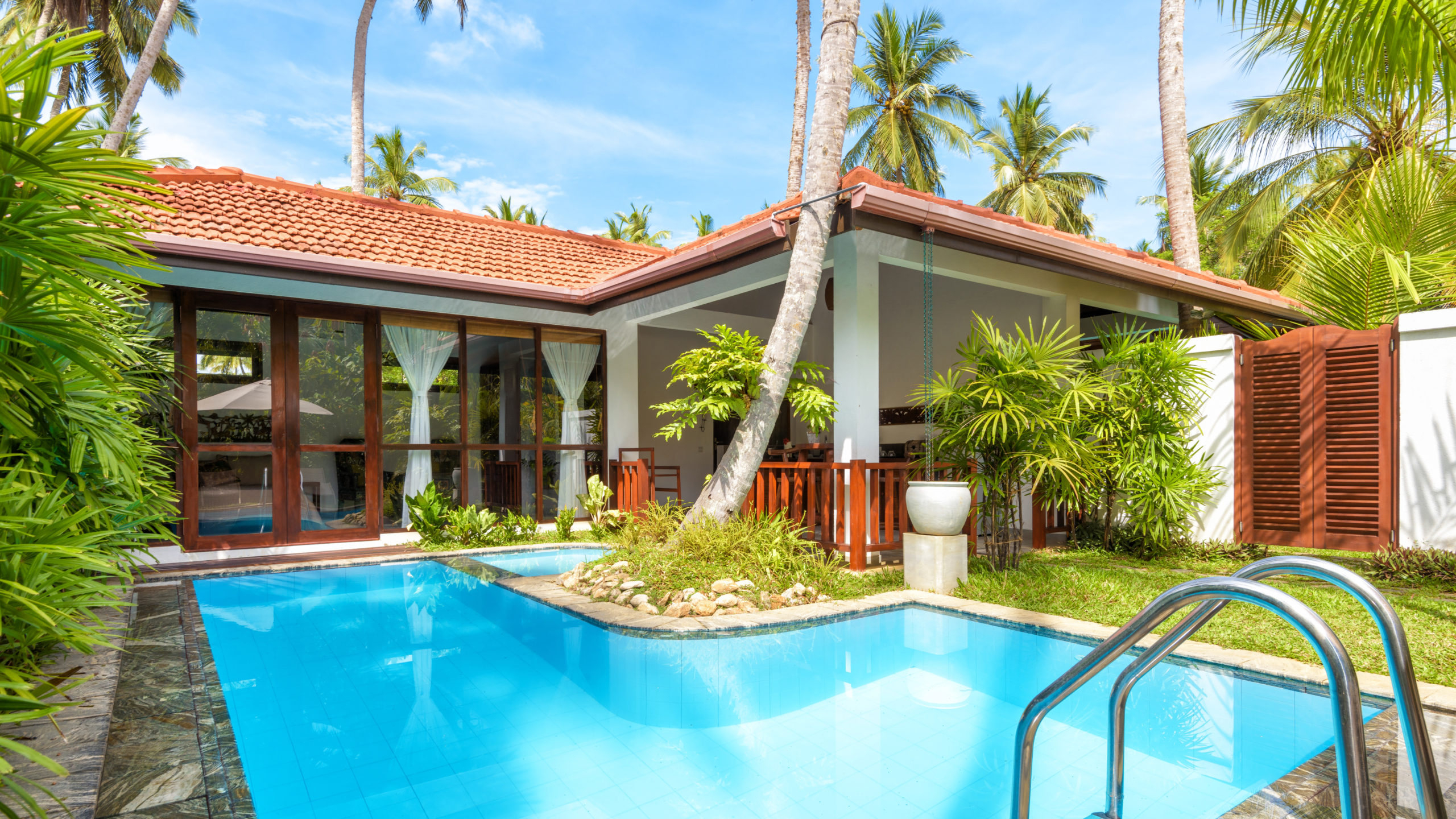 Panoramic view of luxury tropical hotel with pool Sri Lanka - November 4, 2017: Panoramic view of luxury tropical hotel with pool. Sunny villa to relax with idyllic garden. Beautiful swimming pool with blue clean water in courtyard of summer house.